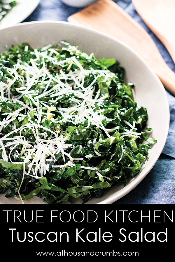 The Tuscan Kale salad from True Food Kitchen is what kale salad dreams are made of!  The kale is lightly tossed in a garlic/lemon dressing with just the right amount of tang. #athousandcrumbs #truefoodkitchen #kale #salad #recipe #paleo #whole30 #keto