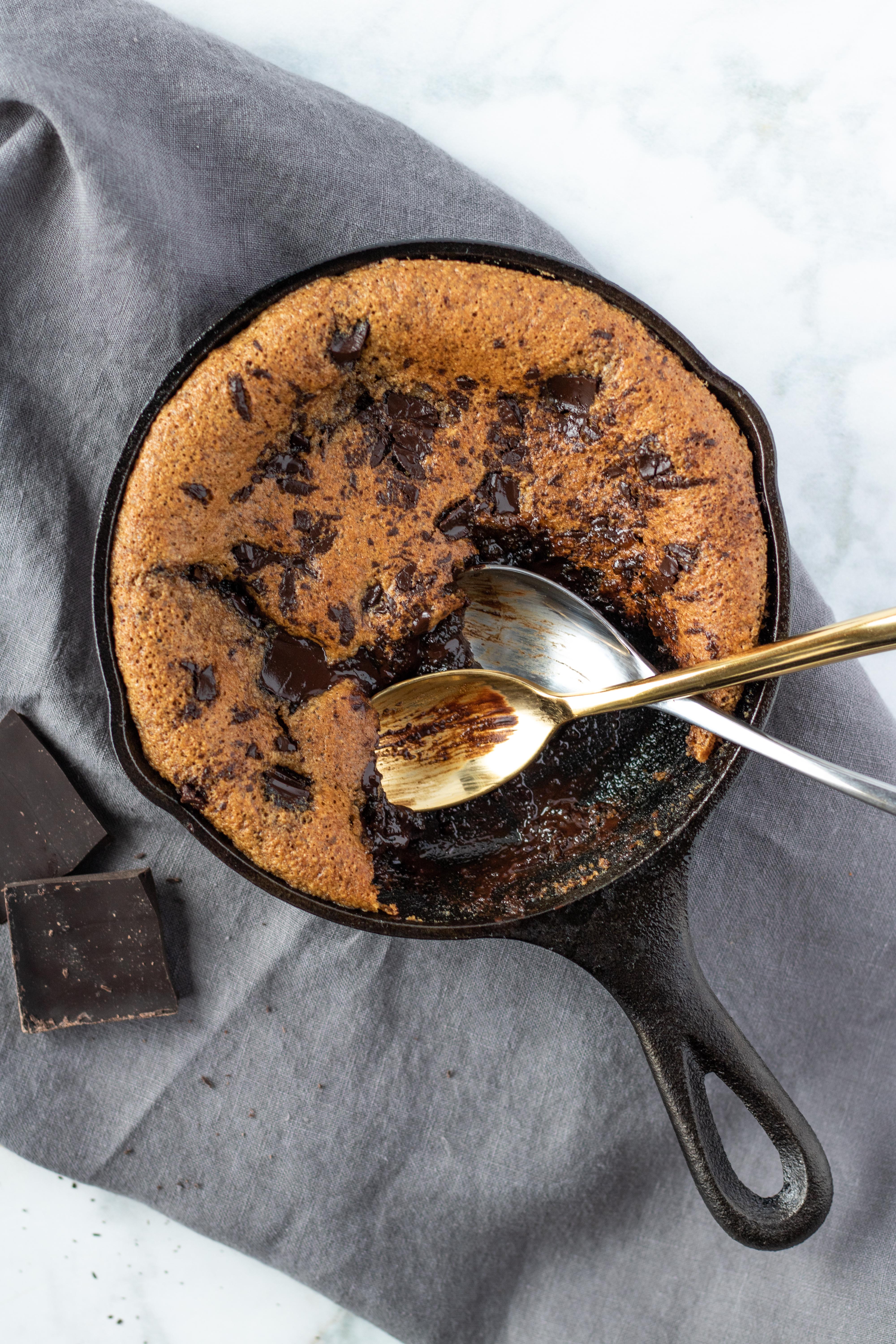 A decadent treat for two, you would never know this skillet cookie is paleo! #athousandcrumbs #glutenfree #skilletcookie #paleo #dairyfree #refinedsugarfree