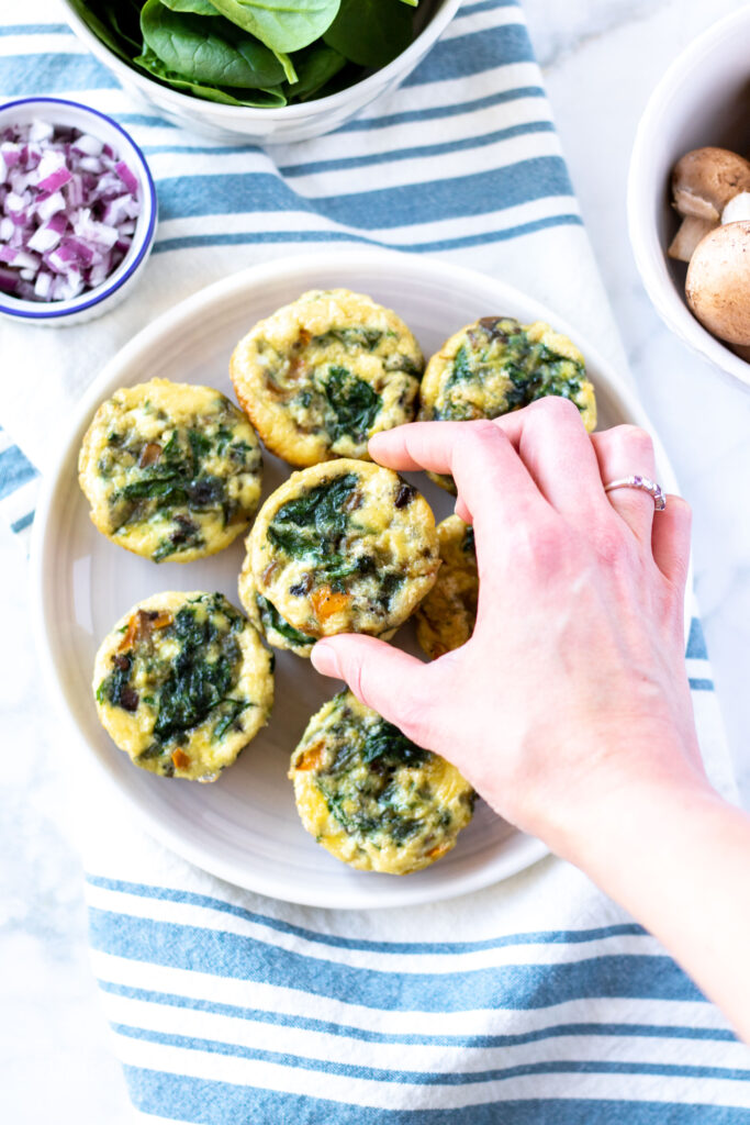 These easy egg muffins are full of flavor and healthy veggies. They are freezer-friendly and an easy grab-and-go breakfast. This egg muffin recipe is paleo, gluten-free, dairy-free, whole30, and keto friendly. #athousandcrumbs #eggmuffins #glutenfree #dairyfree #paleo #whole30 #keto